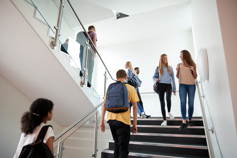 Students walk up a university staircase as they travel to lectures and seminars